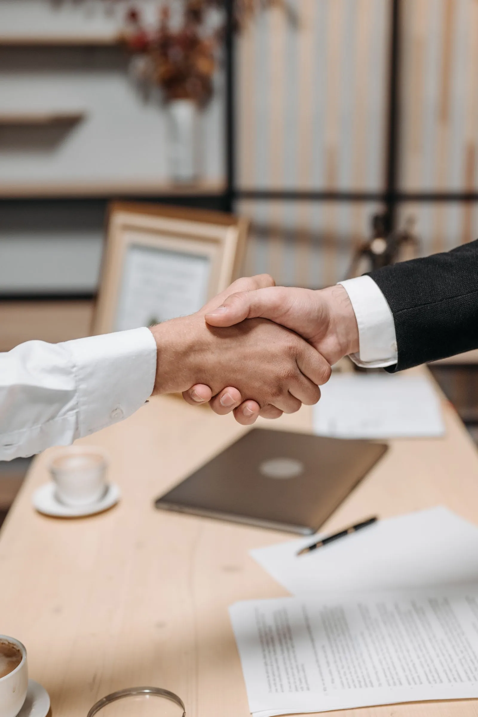 A professional partnership handshake representing government IT procurement